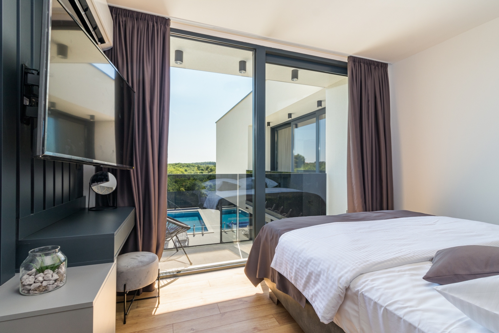 Bedroom with a balcony overlooking the pool