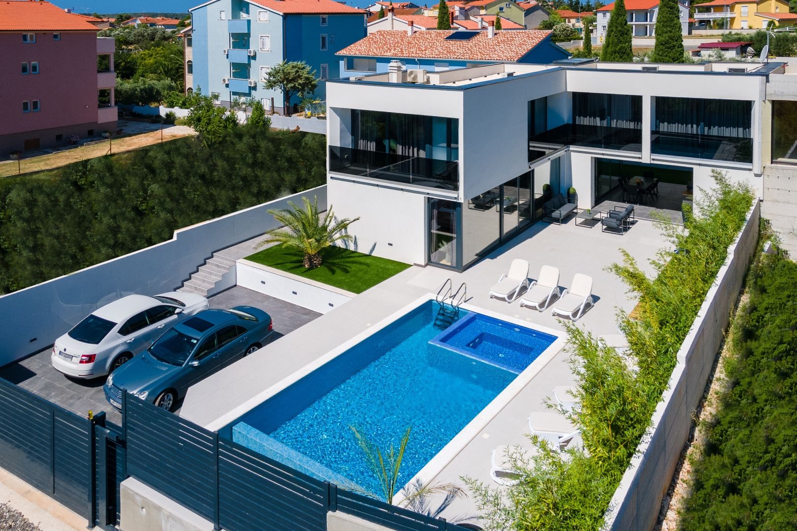 Angled aerial view of the villa exterior and pool
